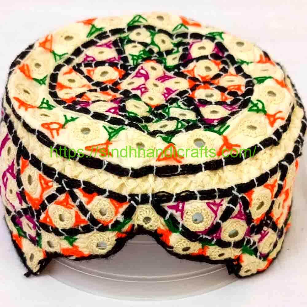 A Sindhi topi and Ajrak cloth displayed together